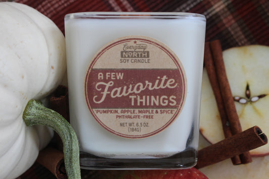 Everyday North Wood Wick Soy Candle. A Few Favorite Things. Pumpkin, Apple, Maple and Spice. Phthalate Free. 6.5 oz. 184 grams. Decor Surrounding Undyed Soy Wax Candle in Cube Glass Jar.