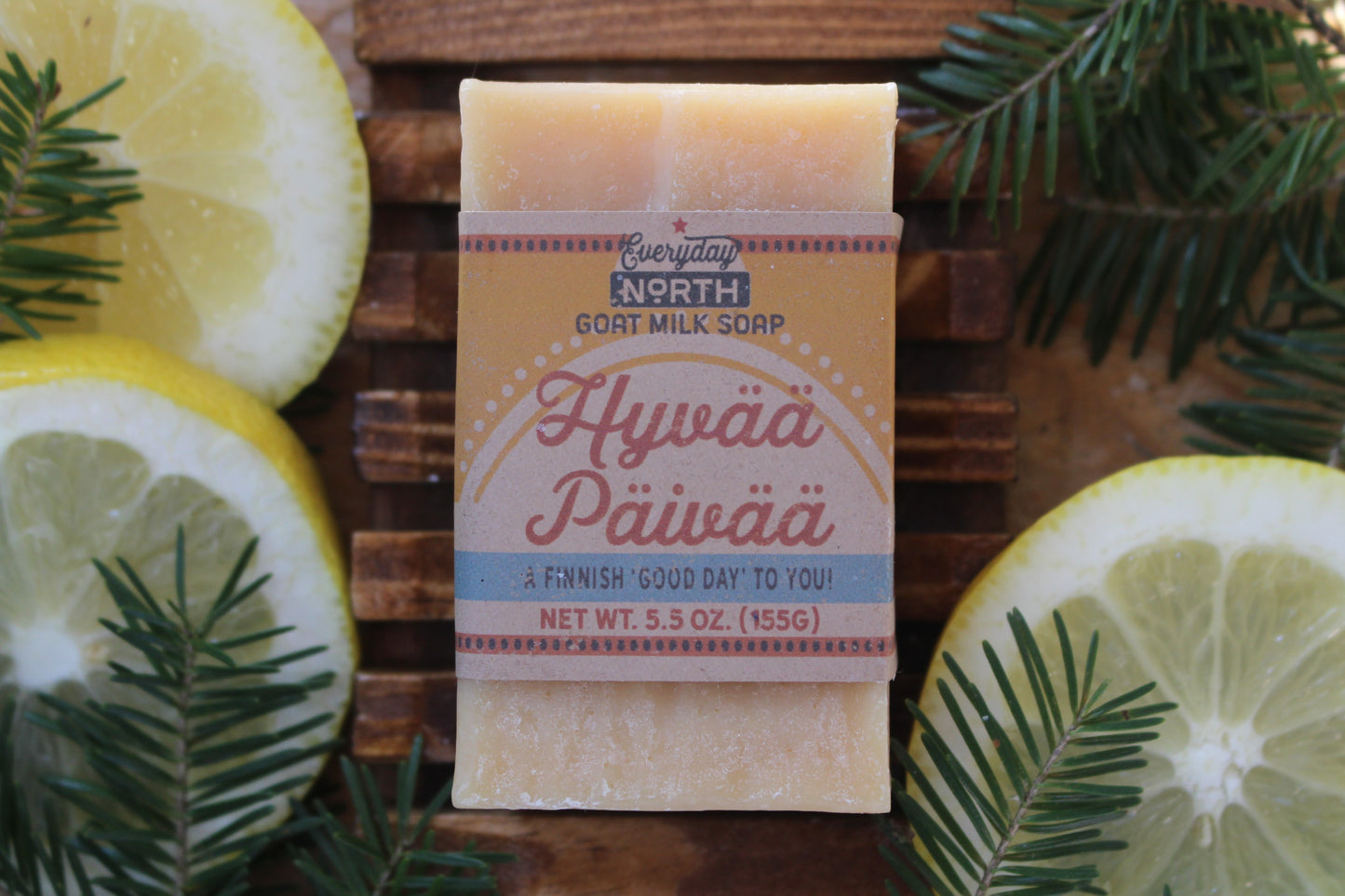 Undyed Soap Bar on Soap Dish. Wrapped in Kraft Label. Everyday North Goat Milk Soap. Hyvaa Paivaa. A Finnish 'Good Day' To You. 5.5 oz. 155 grams. Surrounded by decor.
