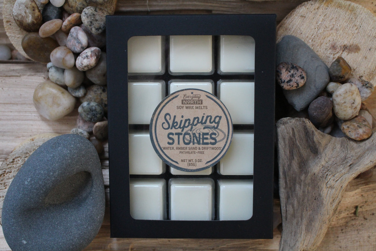 Everyday North Soy Wax Melts. Skipping Stones. Water, Amber Sand and Driftwood. Phthalate Free. 3 oz. 80 grams. Decor Surrounding 12 Tray Wax Melt Undyed Black Box.