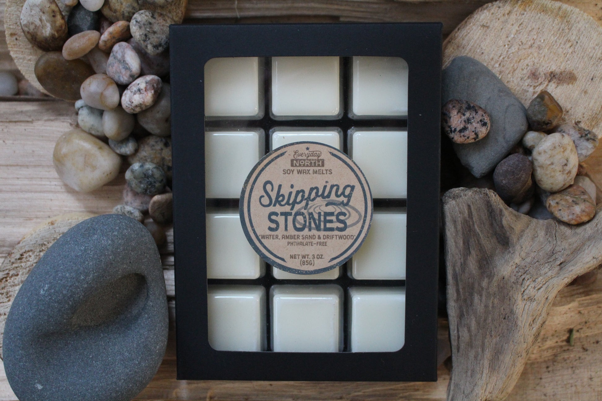 Everyday North Soy Wax Melts. Skipping Stones. Water, Amber Sand and Driftwood. Phthalate Free. 3 oz. 80 grams. Decor Surrounding 12 Tray Wax Melt Undyed Black Box.