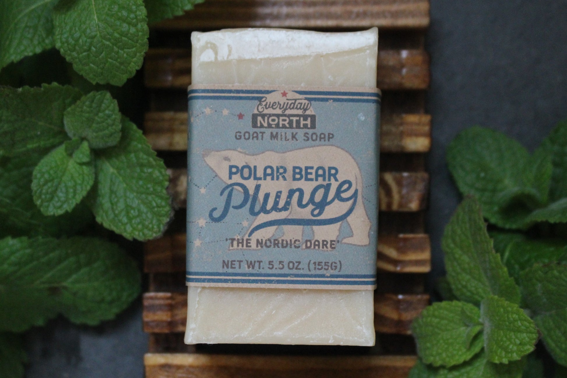 Undyed Soap Bar on Soap Dish. Wrapped in Kraft Label. Everyday North Goat Milk Soap. Polar Bear Plunge. The Nordic Dare. 5.5 oz. 155 grams. Surrounded by decor.