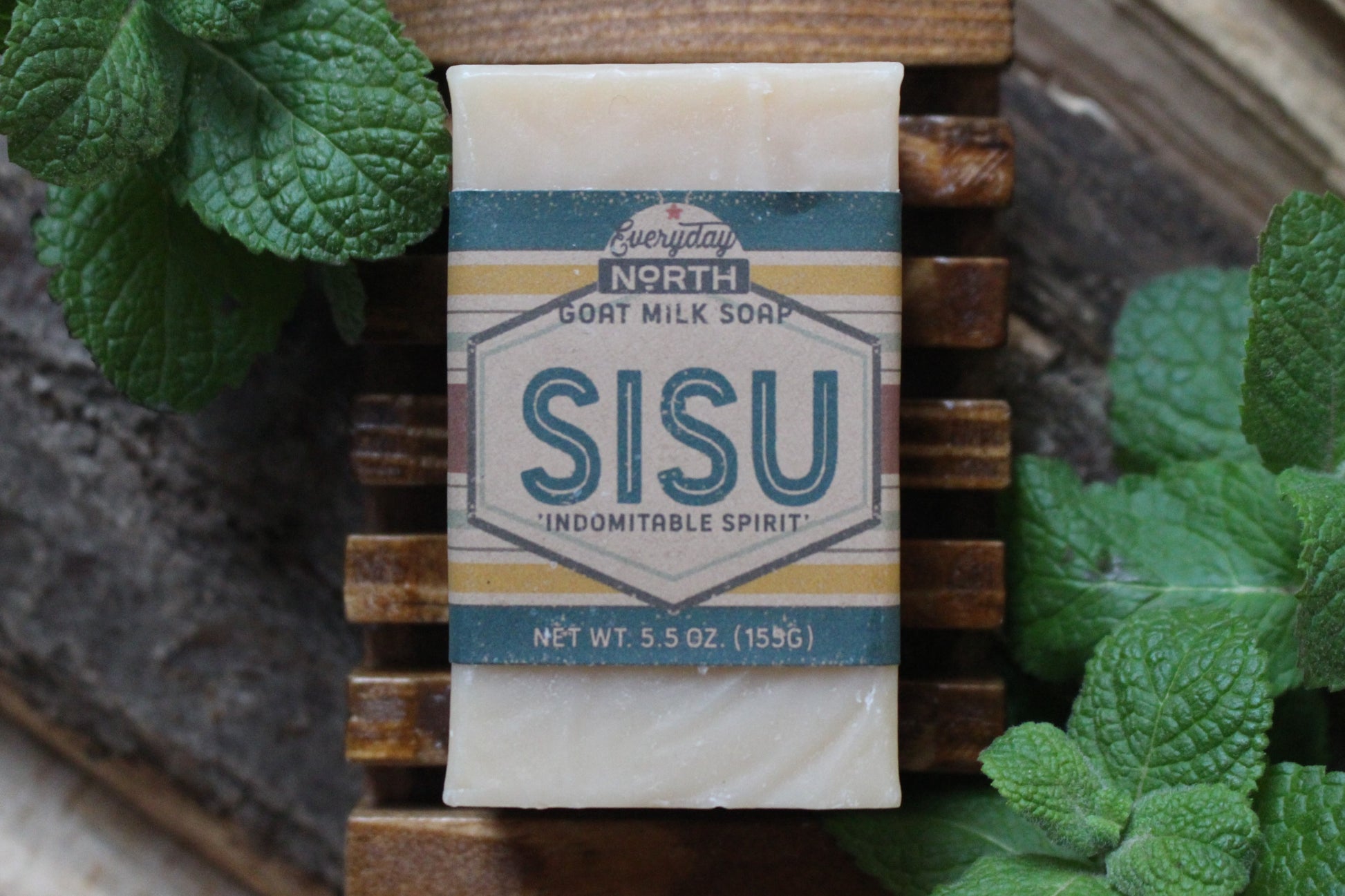 Undyed Soap Bar on Soap Dish. Wrapped in Kraft Label. Everyday North Goat Milk Soap. Sisu. Indomitable Spirit. 5.5 oz. 155 grams. Surrounded by decor.