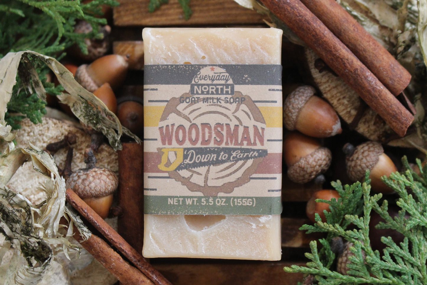 Undyed Soap Bar on Soap Dish. Wrapped in Kraft Label. Everyday North Goat Milk Soap. Woodsman. Down To Earth. 5.5 oz. 155 grams. Surrounded by decor.