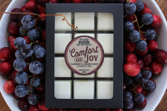 Everyday North Soy Wax Melts. Comfort and Joy. Cranberry and Concord Grape. Phthalate Free. 3 oz. 80 grams. Decor Surrounding 12 Tray Wax Melt Undyed Black Box.