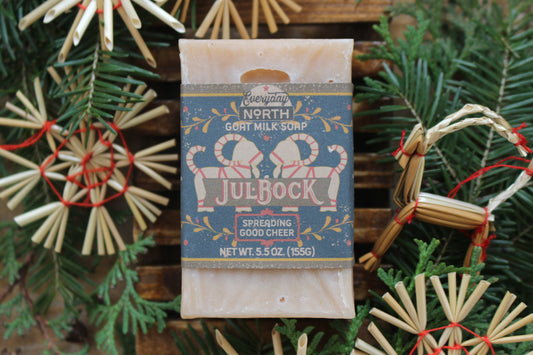 Undyed Soap Bar on Soap Dish. Wrapped in Kraft Label. Everyday North Goat Milk Soap. Julbock. Spreading Good Cheer. 5.5 oz. 155 grams. Surrounded by decor. 