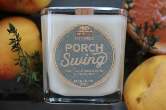 Everyday North Wood Wick Soy Candle. Porch Swing. Peach, Grapefruit and Thyme. Phthalate Free. 6.5 oz. 184 grams. Decor Surrounding Undyed Soy Wax Candle in Cube Glass Jar.