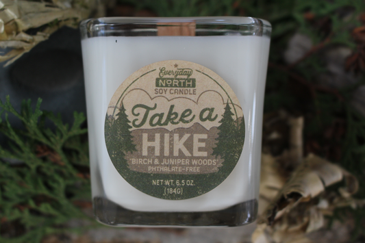 Everyday North Wood Wick Soy Candle. Take a Hike. Birch and Juniper Woods. Phthalate Free. 6.5 oz. 184 grams. Decor Surrounding Undyed Soy Wax Candle in Cube Glass Jar.